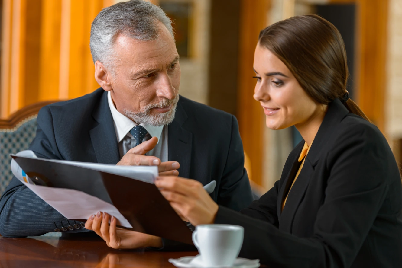 Senior attorney reviewing document with client